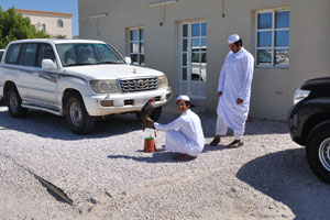 Local people with a falcon are near the Lewan Shamal restaurant in the city of Madīnat ash Shamāl