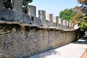 An ancient fortified wall is equipped with battlements