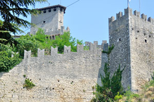 The wall with battlements of the Guaita fortress as seen from Piazzale Cava Antica
