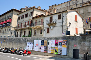 Motorcycles are parked near the San Francesco gate