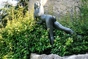 The statue of nude girl is in the park “La pattinatrice di Emilio Greco”