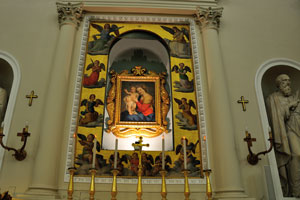 The painting represents a mother and child as the centerpiece framed with angels