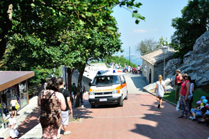 An ambulance car is near the entrance of the Guaita fortress