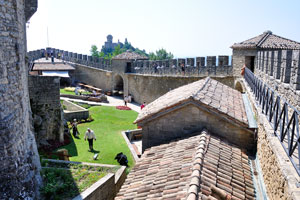 Roofs of tiny buildings inside the Guaita fortress are covered with tile