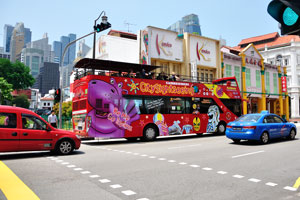 City sightseeing bus drives along South Bridge Road