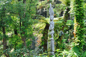 Wooden statues in the lush greenery