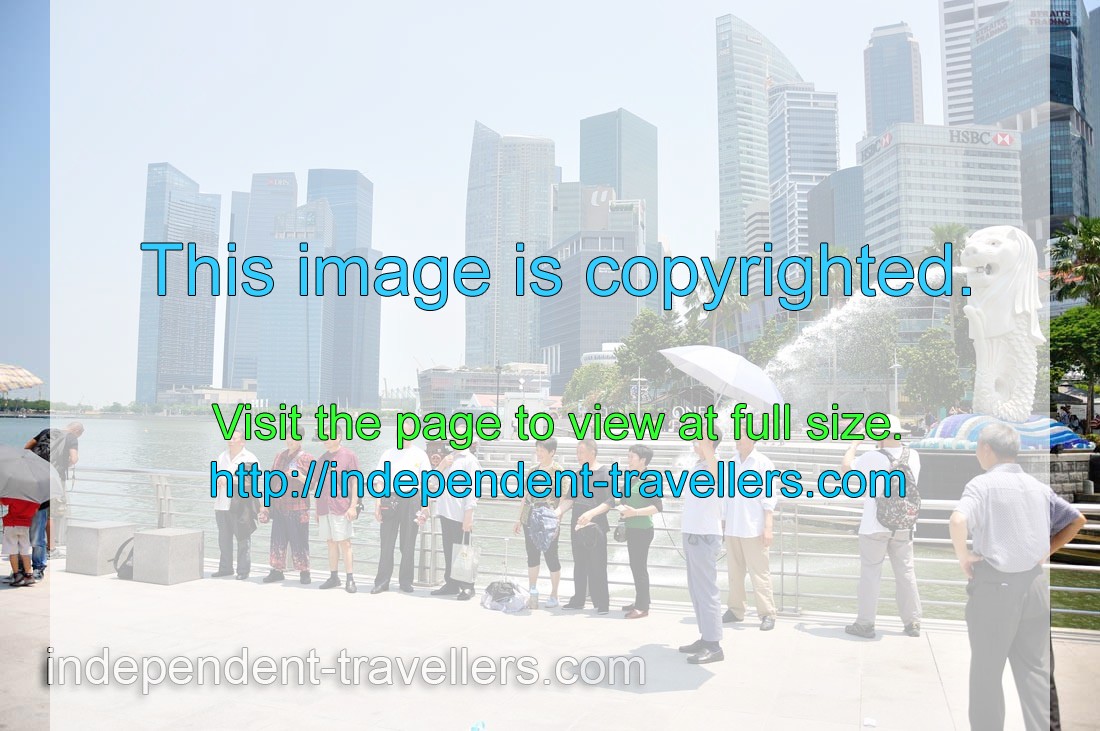 Tourists like to be photographed in front of the Merlion statue