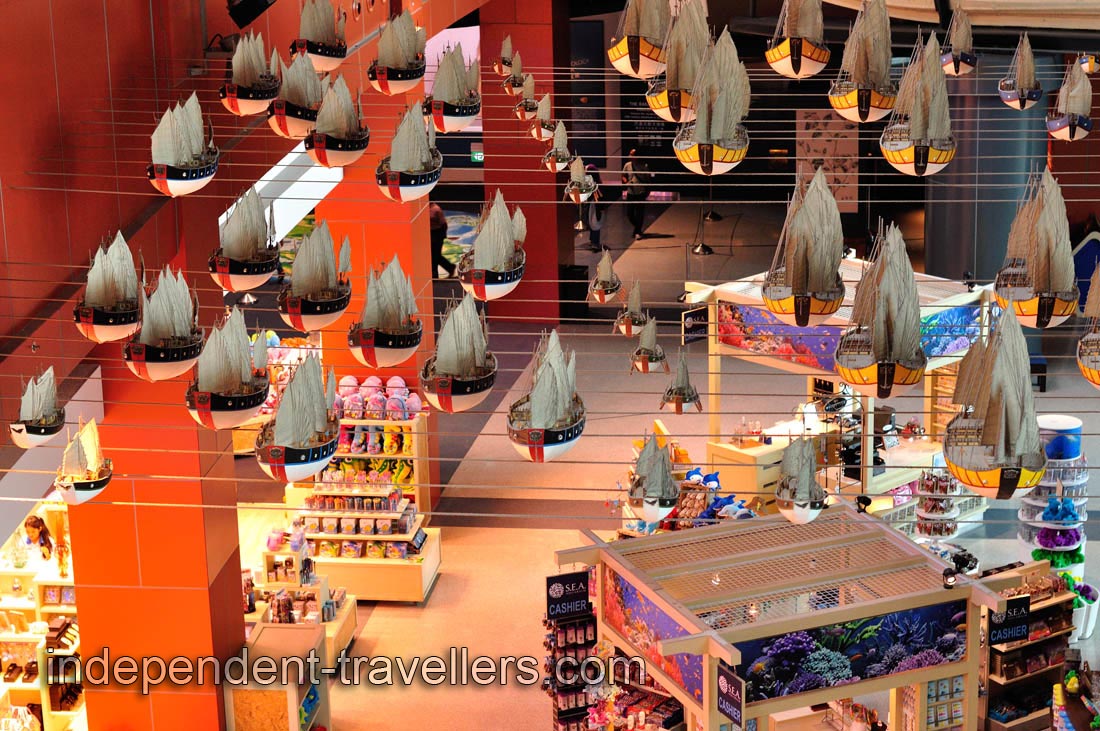 Miniatures of the ships are suspended in the air over the retail shops