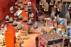 Miniatures of the ships are suspended in the air over the retail shops