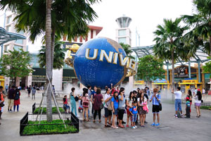 Tourists posing in front of the Universal Globe
