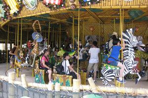 King Julien's Beach Party-Go-Round is a merry-go-round ride that is themed and decorated with all the characters of Madagascar