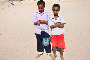 Two boys in Berbera, one of them opens my candy