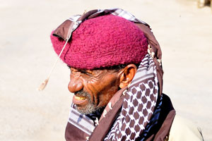 Old Somali man wears the magenta hat