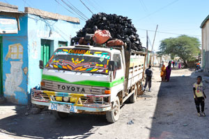 A small truck loaded with charcoal