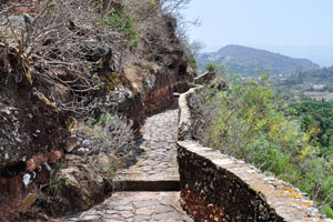 A stone footpath is protected with a stone fence