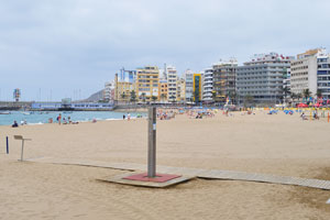 A public beach shower is on the beach of Las Canteras