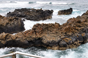 Rocks and waves are near the square of Plaza Alonso Ojeda
