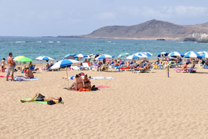 The beach of Gran Playa Canteras is full of the beautiful blue-white parasols