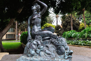 The black statue of a nude woman is located near the Hotel Santa Catalina