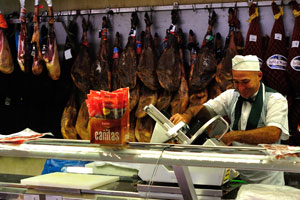 Spanish vendor cuts jamon at El Corte Inglés shopping mall
