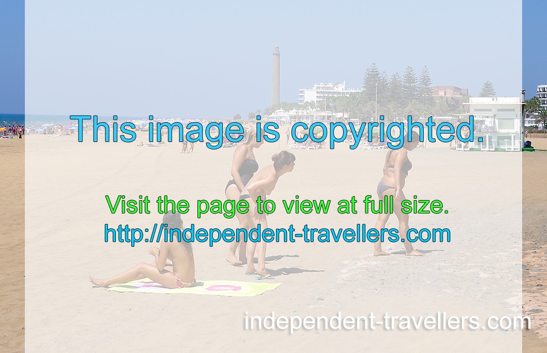 Beautiful topless girls are sunbathing on Maspalomas beach