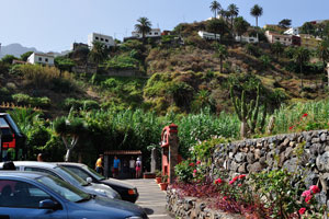 Vehicles are at the parking place in front of “Molino de Gofio Los Telares” garden