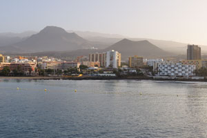 The city of Los Cristianos is on the background of magnificent mountains