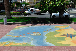 Bright tile on the street is a map informing about how Columbus traveled