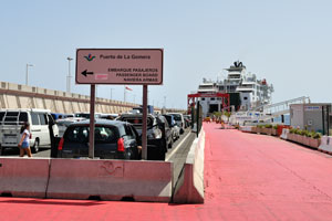 Road sign reads “Puerto de la Gomera, Passenger Board - Naviera Armas”