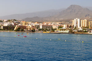 Los Cristianos town is on the background of mountains