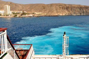 The turquoise water is produced by Naviera Armas engines while docking at ferry slip of Puerto de Los Cristianos port