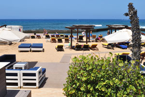 There are sun loungers on Playa de las Américas beach