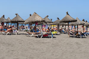 There are wonderful sun loungers with straw roofs on Playa de Troya beach