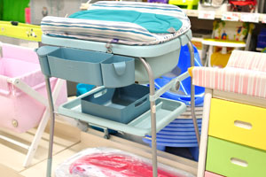 A baby changing table and bath tub stand is in Alcampo hypermarket