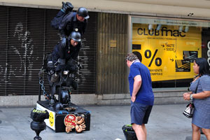 A man gives a donation for street performers on Calle de Preciados street