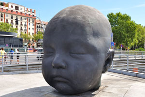 The “Baby head with closed eyes” statue is located at Madrid Atocha railway station