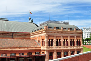 The flag of Spain is placed on the top of Madrid Atocha railway station building