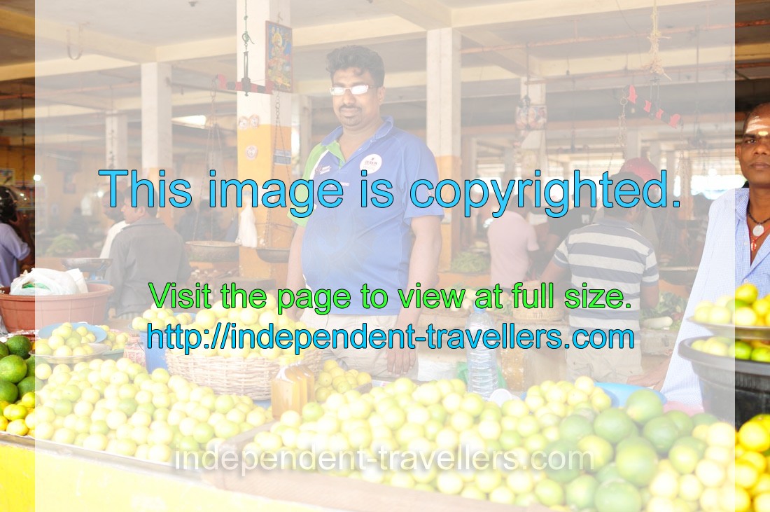 A male vendor sells limes