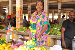 A female vendor sells limes
