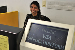 A gorgeous Sri Lankan girl helps to fill the Visa application form