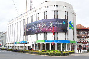 A billboard is located on the wall of Standard Chartered Bank