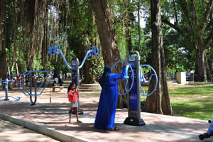 A blue woman is spinning a blue device for entertainment