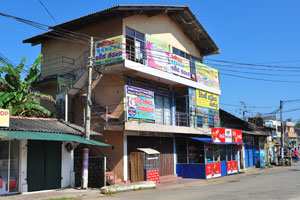 A three storey building with small shops