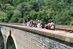 A group of young foreign travelers are on the bridge