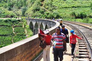 Many tourists gather around and on the bridge in the hour before one of the trains is scheduled to pass over the bridge
