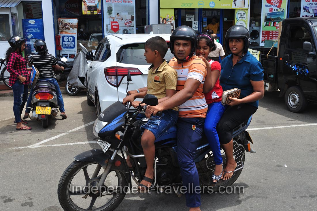 A big family of four rides a motorcycle