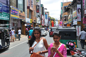 Two young ladies walk along Main street