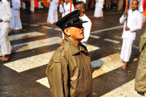 A policeman is dressed in the raincoat