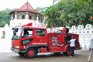 A fire engine is located beside the temple of the Sacred Tooth Relic
