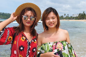 Two lovely chinese ladies are on Mirissa beach